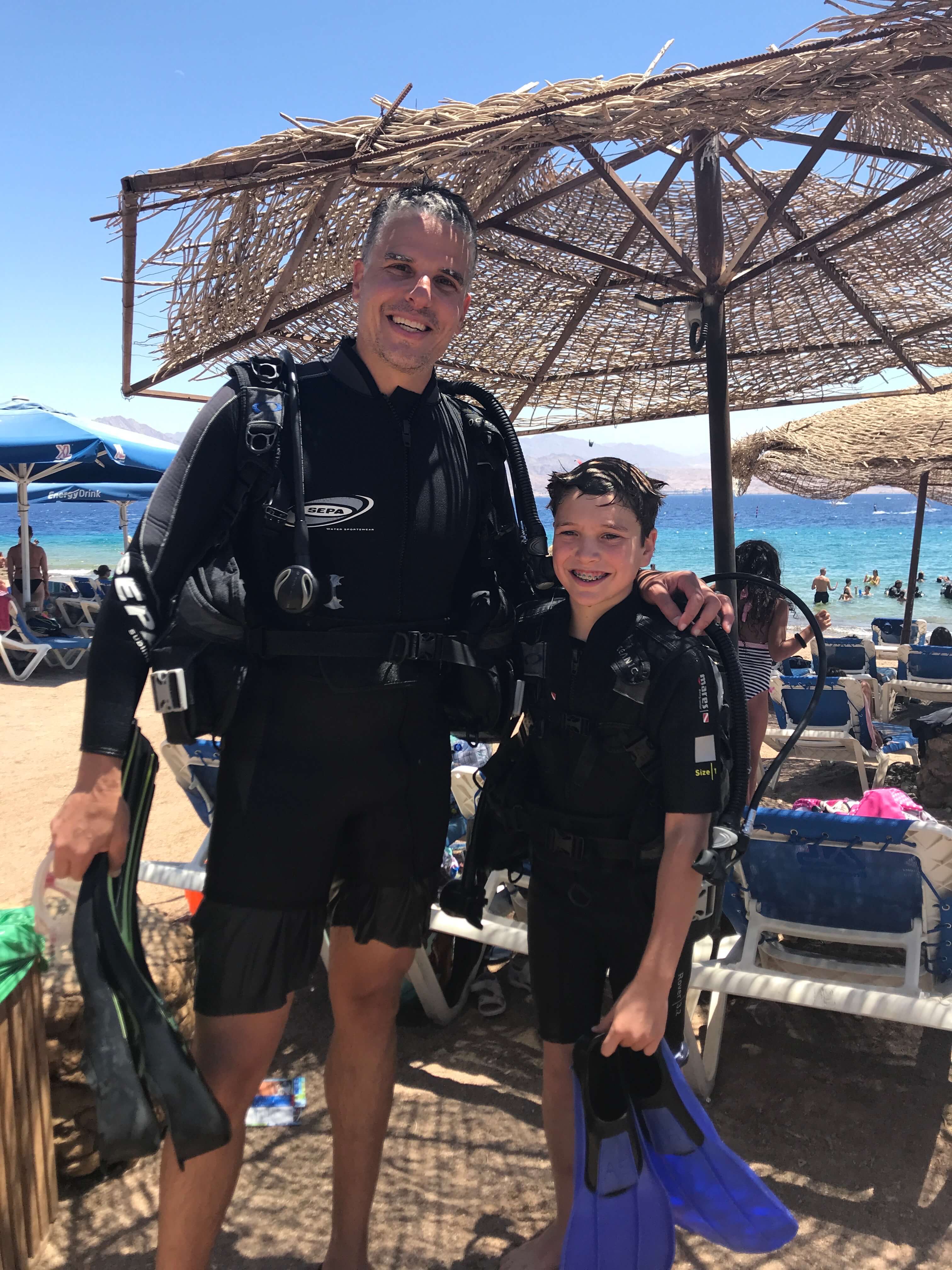 Darren Klugman and his son snorkeling in the Red Sea